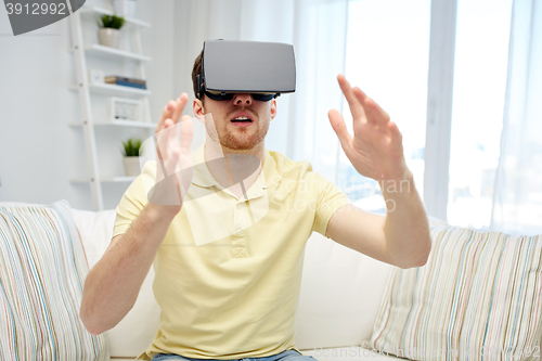 Image of young man in virtual reality headset or 3d glasses