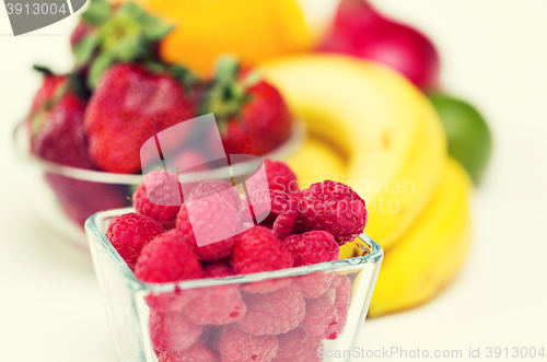 Image of close up of fresh raspberry and fruits on table