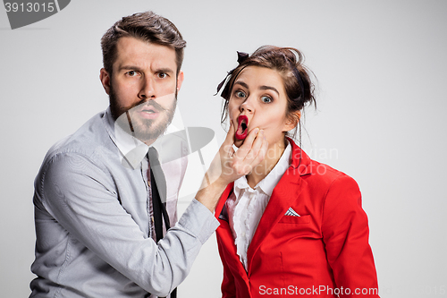 Image of The angry business man and woman conflicting on a gray background