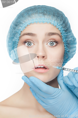 Image of Attractive woman at plastic surgery with syringe in her face