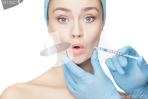 Image of Attractive woman at plastic surgery with syringe in her face