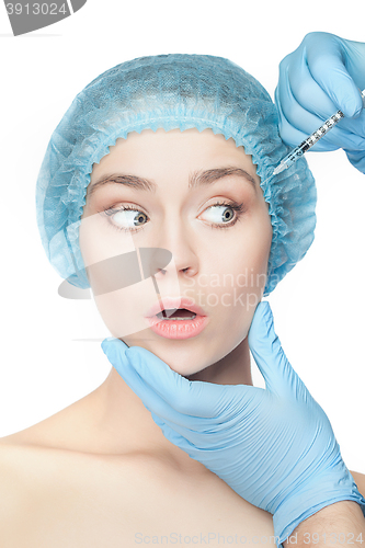 Image of Attractive woman at plastic surgery with syringe in her face