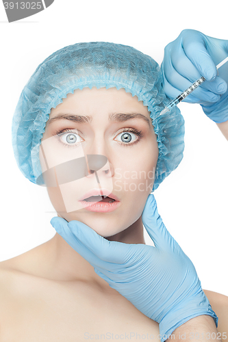 Image of Attractive woman at plastic surgery with syringe in her face