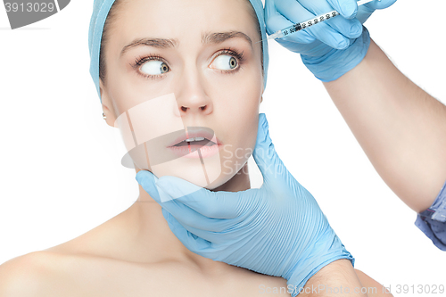 Image of Attractive woman at plastic surgery with syringe in her face