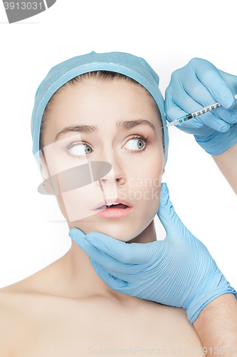 Image of Attractive woman at plastic surgery with syringe in her face