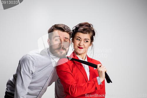 Image of The business man and woman cooperating on a gray background