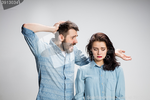 Image of The young couple with different emotions during conflict