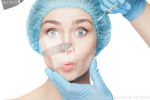 Image of Attractive woman at plastic surgery with syringe in her face