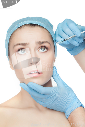 Image of Attractive woman at plastic surgery with syringe in her face