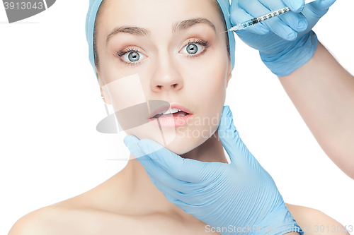 Image of Attractive woman at plastic surgery with syringe in her face