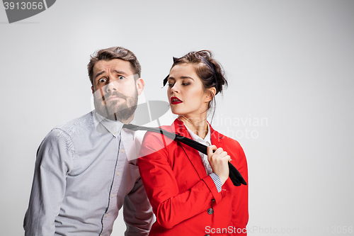 Image of The business man and woman cooperating on a gray background