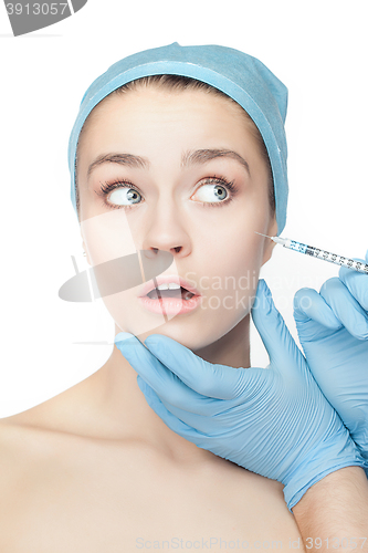 Image of Attractive woman at plastic surgery with syringe in her face