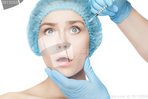 Image of Attractive woman at plastic surgery with syringe in her face