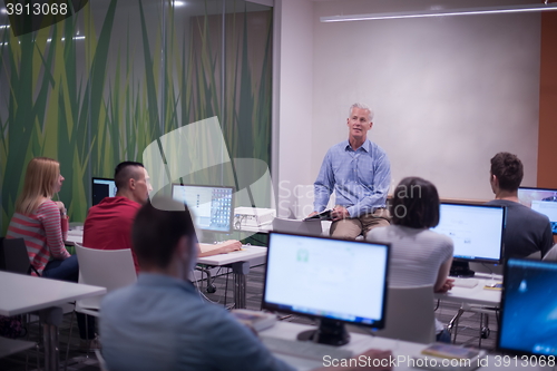 Image of teacher and students in computer lab classroom