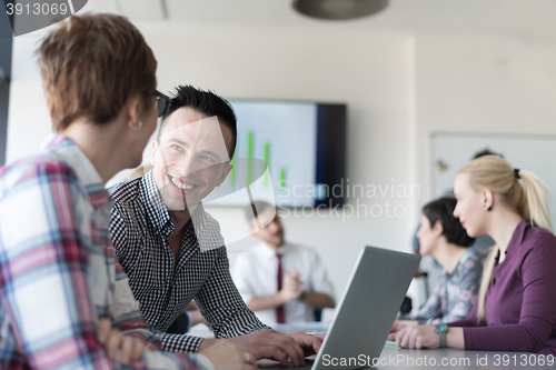 Image of young business couple working on laptop, businesspeople group on