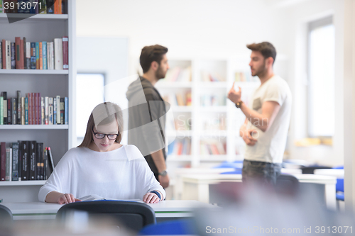 Image of female student study in school library, group of students in bac