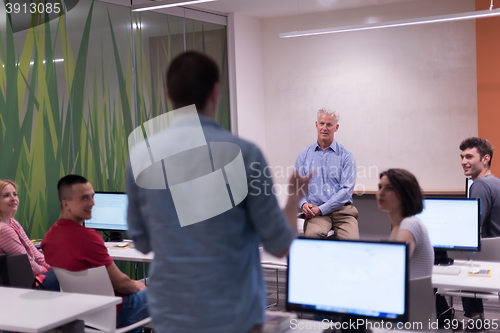 Image of student answering a question in classroom