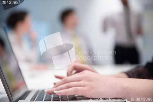 Image of woman hands typing on laptop keyboard at business meeting