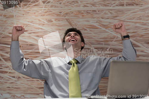 Image of young business man  working on laptop  computer at modern office