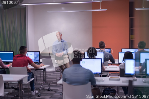 Image of teacher and students in computer lab classroom