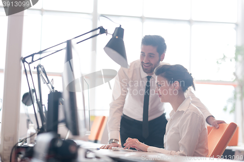 Image of business couple working together on project