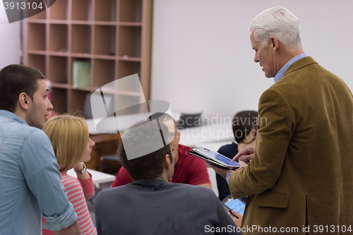 Image of teacher with a group of students in classroom