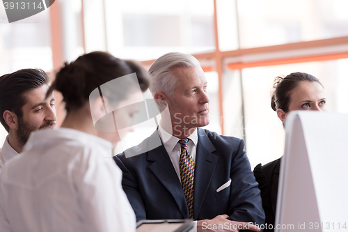 Image of young startup businessman making presentation to senior investio