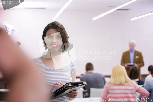 Image of portrait of happy female student in classroom