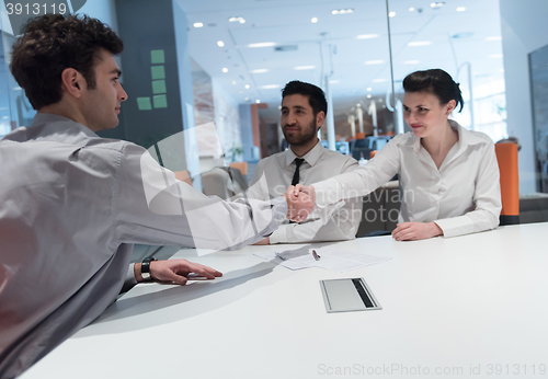 Image of young couple signing contract documents on partners back