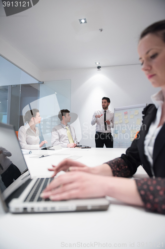 Image of young business woman on meeting  using laptop computer