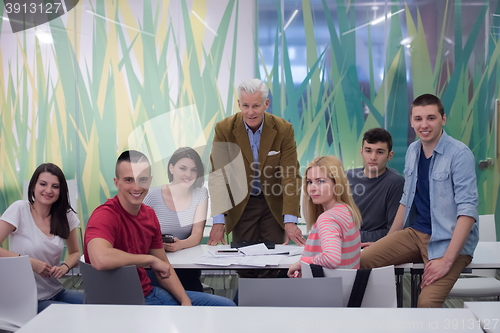 Image of portrait of  teacher with students group in background