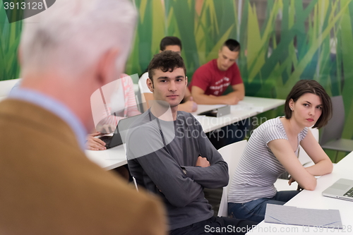 Image of teacher with a group of students in classroom