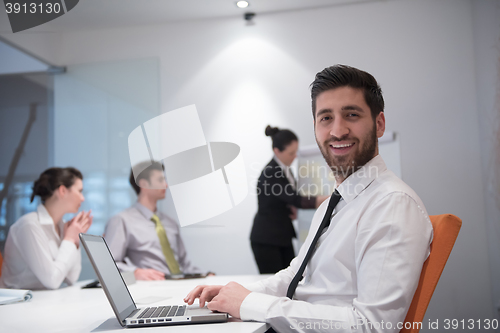 Image of young business man at meeting