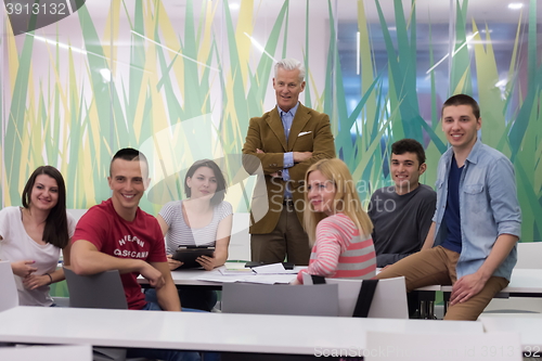 Image of portrait of  teacher with students group in background