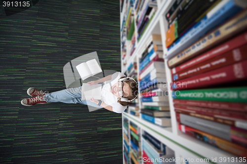 Image of female student study in library, using tablet and searching for 