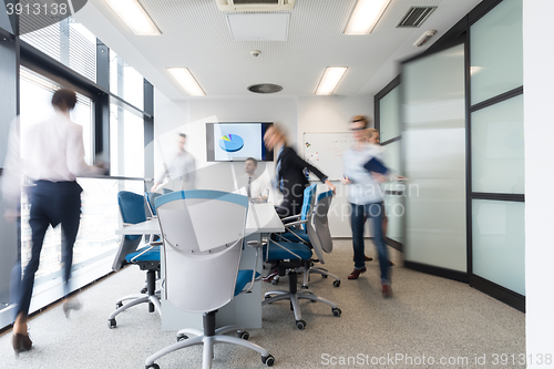 Image of business people group entering meeting room, motion blur