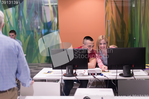 Image of teacher and students in computer lab classroom
