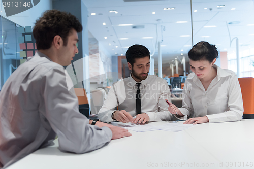 Image of young couple signing contract documents on partners back