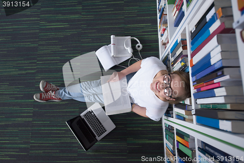 Image of female student study in library, using tablet and searching for 