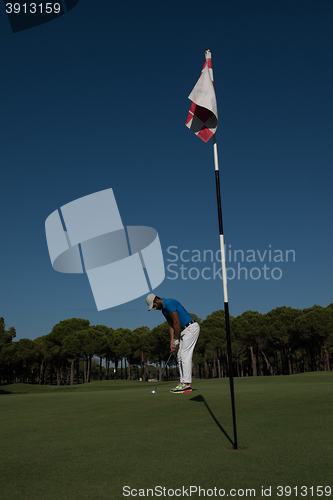 Image of golf player hitting shot at sunny day