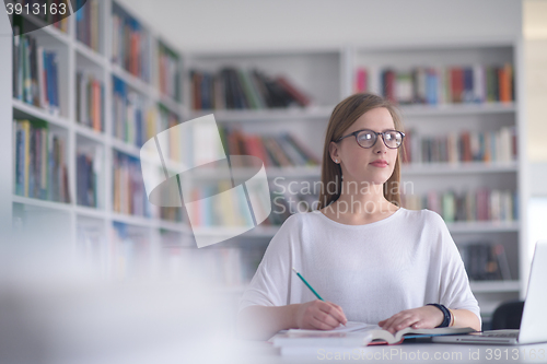 Image of female student study in school library