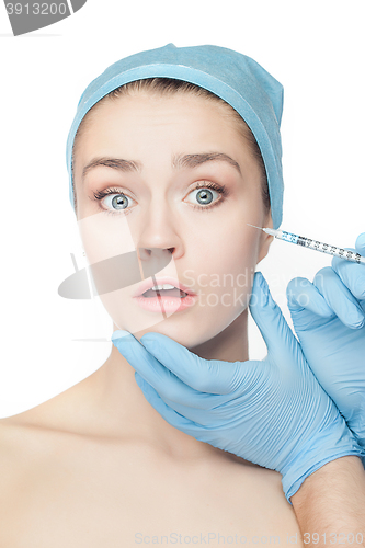 Image of Attractive woman at plastic surgery with syringe in her face