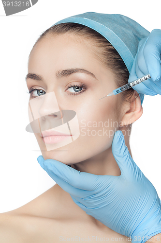 Image of Attractive woman at plastic surgery with syringe in her face