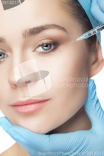 Image of Attractive woman at plastic surgery with syringe in her face