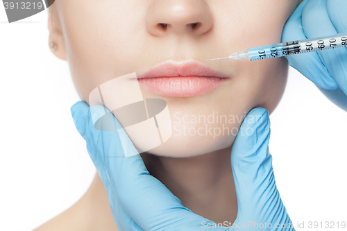 Image of Attractive woman at plastic surgery with syringe in her face