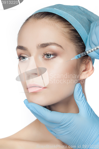 Image of Attractive woman at plastic surgery with syringe in her face