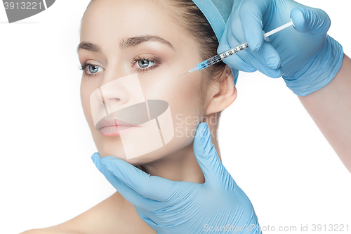 Image of Attractive woman at plastic surgery with syringe in her face