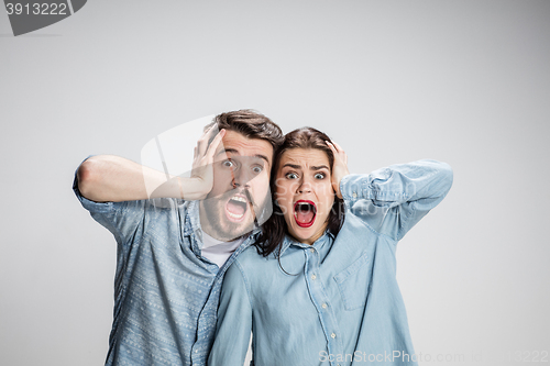 Image of Close up photo of angry man and woman touching their heads