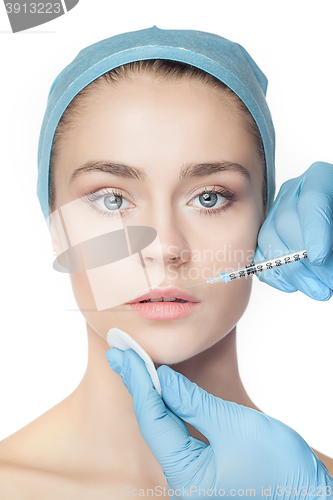 Image of Attractive woman at plastic surgery with syringe in her face