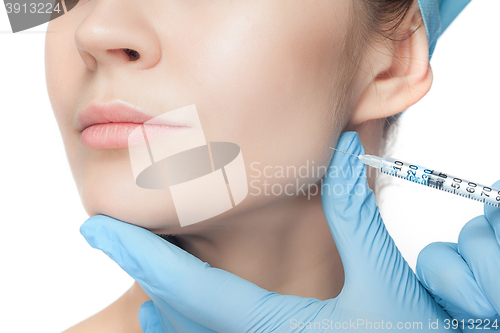 Image of Attractive woman at plastic surgery with syringe in her face